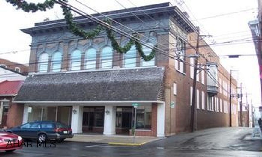 2 story brick building with original arcitectual design. hardwood flooring and carpeting. Great location in town.