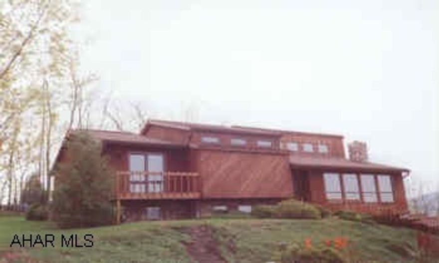 LIFESTYLE HOME IN ROLLING HILLS.  CEDAR CONTEMPORARY MULTI-LEVEL OFFERING GAS FA HEAT WITH CENTRAL AIR, 3 BEDROOMS, CATHEDRAL CEILINGS, DECK OFF MASTER BEDROOM WITH FANTASTIC VIEW, SUNKEN LIVING ROOM WITH FIREPLACE, FAMILY ROOM WITH BAR, PROFESSIONALLY LANDSCAPED.