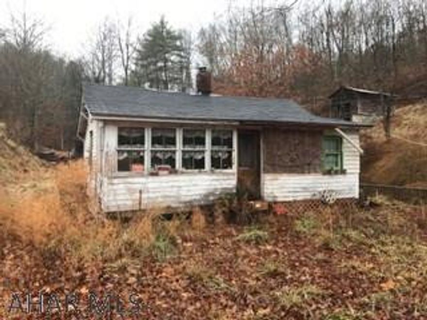 20 acres on nice lot. House is in unknown condition. Electric is unknown. Stairway to top of property. Sold AS-IS. Enter at own risk.