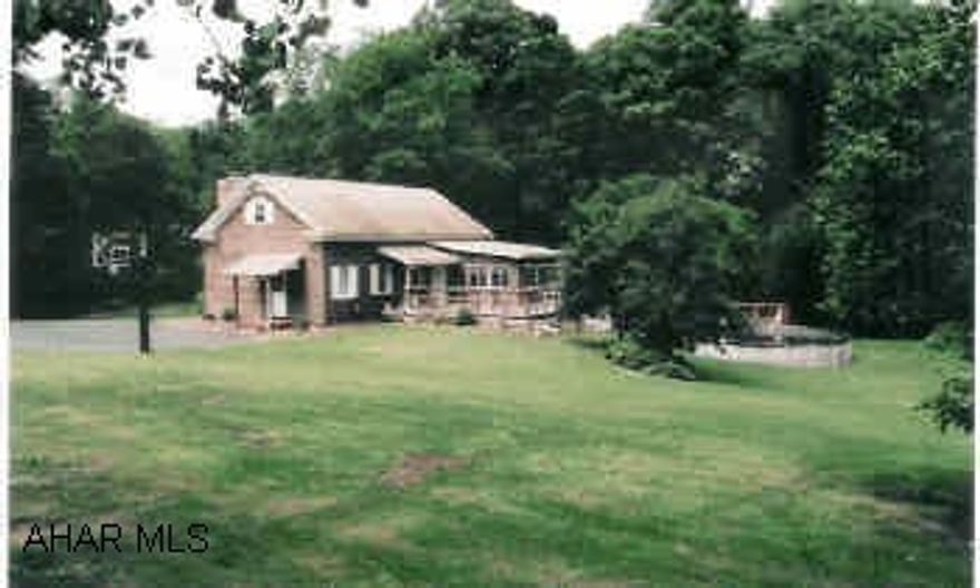 Nice Cape Cod (1 1/2 story) with large yard and woods near stream. High ceiling living room gives a spacious feel w/convenient laundry room and sun room adding to first floor area. Large Master Bedroom w/near-by 3/4 bath, convenient kitchen w/bar.  Room for two bedrooms upstairs.