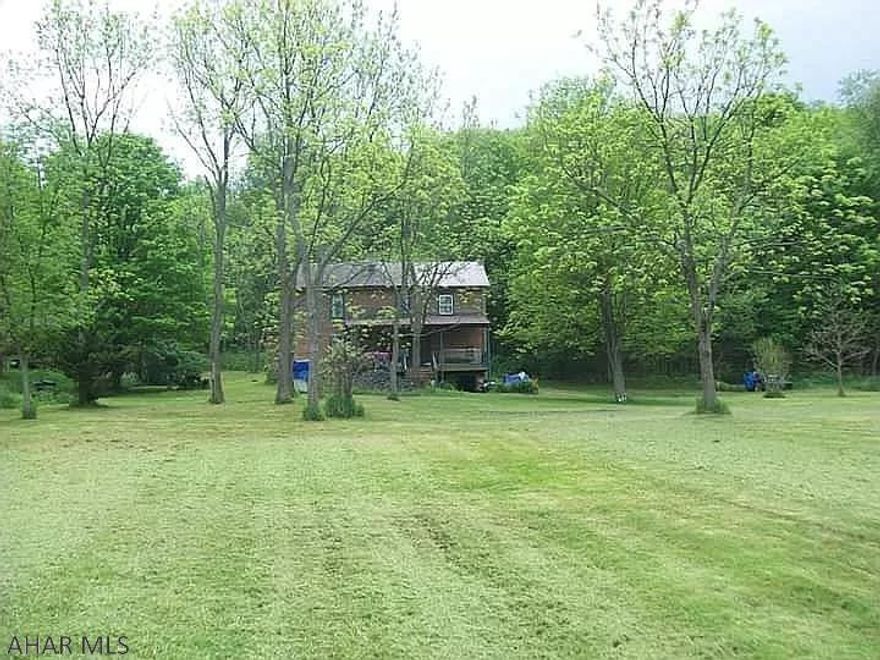 1880 farmhouse with chestnut plank floors, 2 bedrooms, 1 bath, upper floor sitting area, kitchen, living room, dining area, greenhouse style sun room and small cellar. Some remodeling has been done. New metal roof installed 2012. A great deal of potential to update. There is an apple and pear orchard, a stream runs through and multiple springs, previously plowed fields, along with timber area. Also potential gas well on property.