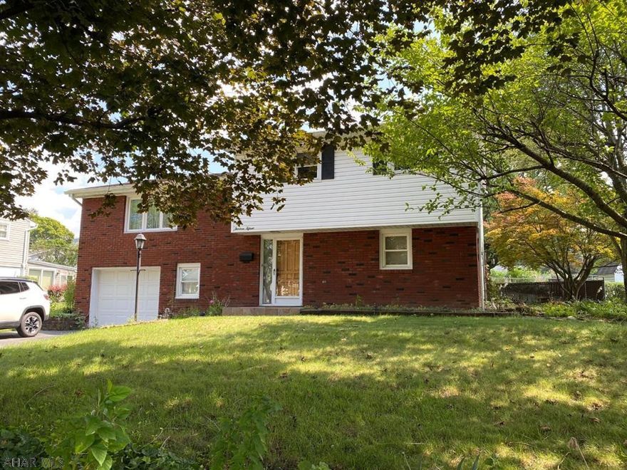 You will love calling this home!  Immaculate condition.  Enjoy entertaining in the spacious family room and an attached three season room.   Fenced in yard with a waterfall.  Outdoor grill with plumbed gas.  Property includes two storage sheds. Three zone heating system. Master bedroom has walk-in closet.