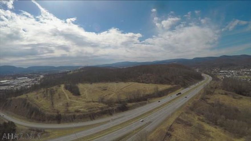 Over 35 acres of prime commercial land with frontage on both side of I-99!  Available together as one property or will subdivide into 2 parcels.  Approx 23.03 acres off I-99 North adjacent to The Altoona Grand Hotel on Plank Road for $1.8 million.  Approx 12.94 acres off I-99 South and Goods Ln right across the street from the Logan Valley Mall for $1.2 million. Yellow lines highlight the approx 23.03 acre parcel, blue lines highlight the approx 12.94 acre parcel.  All property lines in photos are approx.