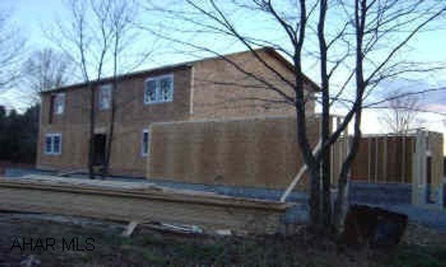 2 story home, 2464 sq' with 2 car att garage. 12x16 rear deck, front porch with roof. Framed as of 11/15/04. Completion by 4/01/04. As of 11/26/04 the home is partially sided, drywall started, furnace in.