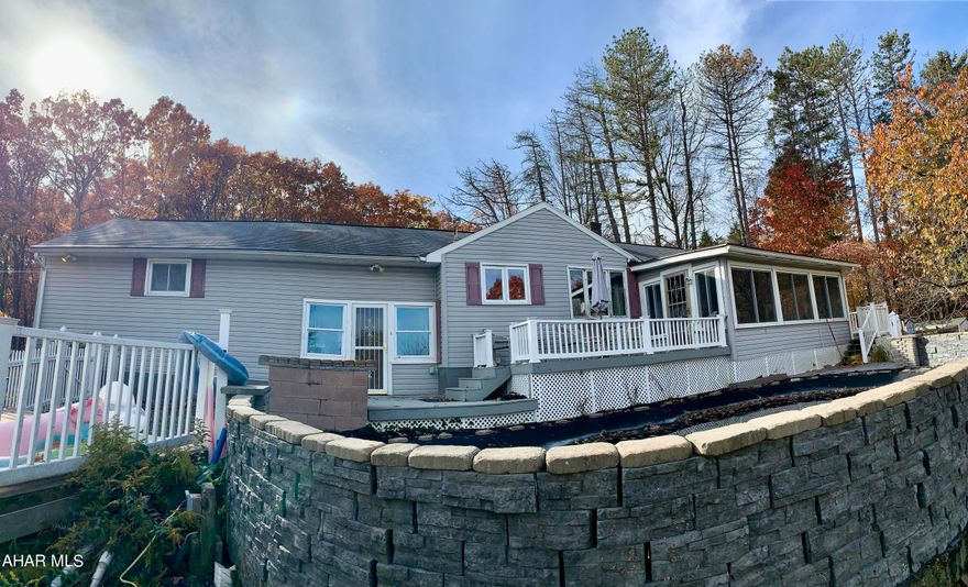 Check out this large ranch style home in a beautiful setting with almost an acre of land. Enjoy your summer days by relaxing in the swimming pool which over looks an astonishing view. This home offers beautiful wood work throughout to give you a cabin feel! Attached to the property is an apartment in which you could possibly rent out for extra income, use as a guest area, or even as an In-law suite! The possibilities are endless!! Schedule your showing today!!