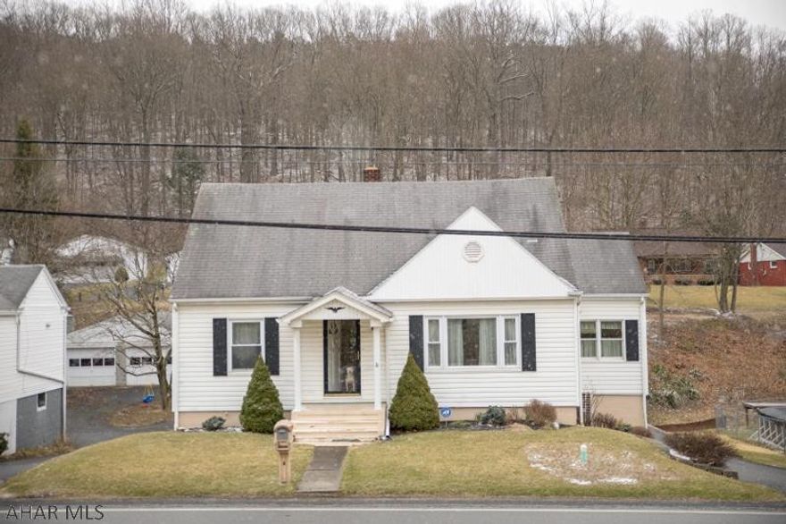 This house is definitely worth a tour. Much bigger than it looks from the outside. 2 bedrooms main level and 2 upstairs. 2 full baths with a very nice kitchen with breakfast counter. 2 new wall units w/ heat and air conditioning. Plenty of parking in the rear with integral garage, paved drive. Lots of yard in the back. Make this home your own. Call today!