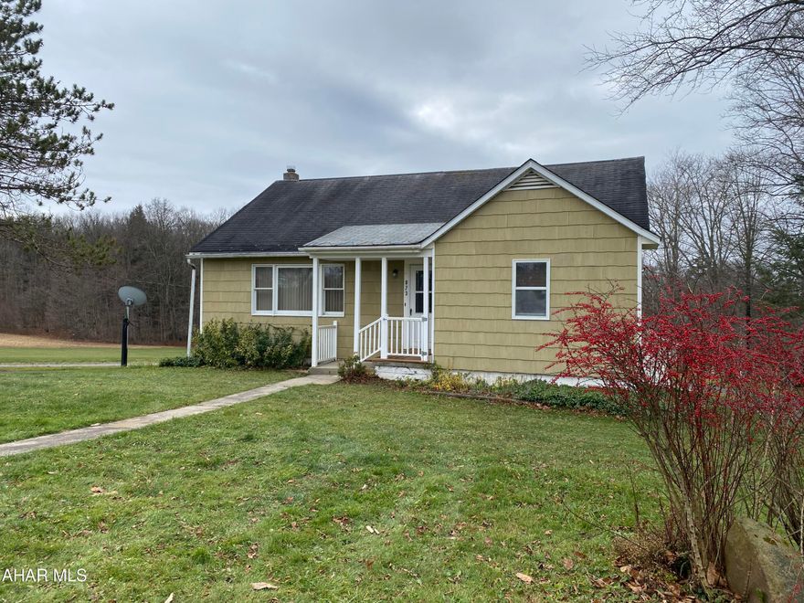 Almost 2 acres of privacy in Forest Hills school district, large living and dining room with newer carpet, two bedrooms on the main floor with full bath, hardwood floors under the carpet on the main floor except room with fireplace, lots of storage area, attic is finished and heated for additional living area, square footage is approximate based on tax records and inspection, buyer to verify, semi-finished basement that walks out at ground level, integral garage and detached oversized two car garage