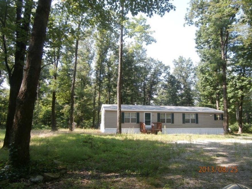 Nice doublewide on wooded acreage. Private location. Home in good condition. No basement.