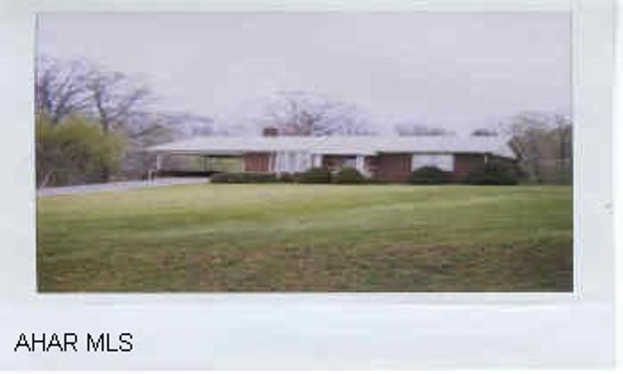 Built in 1961-1.4 acre,copper plumbing, plaster walls, hardwood floors, gas & electric, lots of off street parking, Brick grill on patio, / carport-cement slab is old septic crushed and filled in.  Possibly cn be Commercial. Lot in rear which has street entrance can be subdivided.