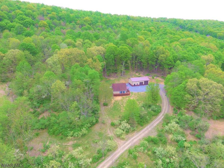 Hard to find Getaway in the Mountains with 17+/- acres located a short distance from PA State Game Lands. This property Would make an ideal recreational cabin to get away from the hustle and bustle or a full time residence with privacy. Home offers 2 bedrooms, 2 baths including a master bath, cathedral ceilings, 30x48x14 detached garage with heated and cooled work shop, and so much more. The large inviting deck allows you to enjoy the private setting and beautiful mountain views.