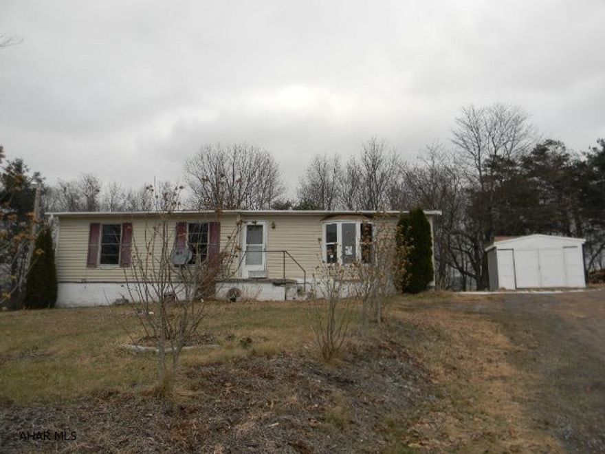Older doublewide 3 bedroom, 1 full bath on full foundation with enclosed porch, two sheds, partially wooded acre with nice country view. Needs work! Offered AS-IS and immediately available!