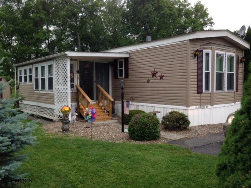 Well kept 14x74 Parkwood singlewide in beautiful Friendship Village. Like brand new with so many upgrades including 36 house doors, new thermal pane windows throughout, extra wrap 6 insulation, perimeter hot air heat, quality plywood underlayment, 8' ceilings, propane fireplace, laminate floors, exceptional vinyl plantation shutters throughout, built-in buffet, oak cabinets, new appliances, walk in shower with seat, separate laundry room, closed in sunroom, private porch, outdoor shed, and so many more extras. Exceptionally maintained and move in ready!