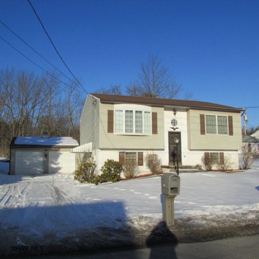 Adorable and well-maintained home with 3 BR & 2 Baths. Paved driveway to 2-car garage. The lower level is ground level - you enter through the family room.  There's also a bedroom and large full bath on this floor along with a laundry area.  Plenty of room here for a small kitchen if needed for in-law suite. The upstairs has two bedrooms with nice closets. Full bath with a skylight and pickled oak vanity, mirror and cabinet. The kitchen has a pantry, eat-in bar area and nice view out the window. A 17x10 deck accessed from the dining area that is semi-private plus boasts reports of deer and wildlife sightings. Well built with 2x6 walls.  Newer carpet throughout the upstairs. Nice big closets throughout and storage downstairs. Really low utilities and low maintenance - don't miss this one!