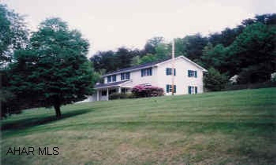 Two story traditional on large 2 acre lot overlooking Bedford Springs Golf Course