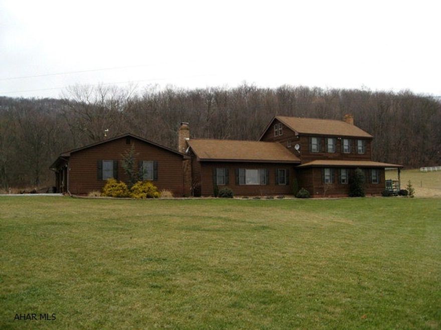 Beautifully remodeled home situated on 100 ac (fields and woods). Large rooms, many extras including convenient 1st floor master bedroom, large fireplaces, new heat pump, hardwood floors, etc. Out buildings include a newer 2-story garage/workshop. Three ponds, stream, wraparound deck. Great for horses or cattle. Wooded hills provide ideal hunting area. This one must be seen to be appreciated!!