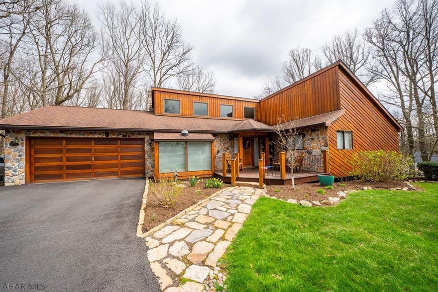 Sylvan East contemporary beauty. Cedar sided, vaulted ceilings and a wooded backyard...perfect for entertaining or relaxing by the fire pit.  Main level boasts 3 nicely sized bedrooms and 2 baths.  Open, spacious design....bright breakfast nook, kitchen island.....all lead into the great room, complete with a cozy fireplace.  Doors lead to the multi-level deck and fire ring.  Enjoy the deer right in our own backyard.  This home has been updated and upgraded...new hardwood floors, cherry doors, SS appliances, new bathrooms.  The daylight lower level has it's own stone fireplace, computer space, bonus rooms (4th BR?) and a walkout to the screened porch.  There is plenty of space for everyone. Hot water heat-4 heat zones, C/A,  tons of storage.  This property is a quality home.