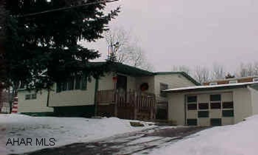 well kept double wide on foundation with one car garage.  New plush carpet throughout. lovely wooded lot. 95x113  Take a look!