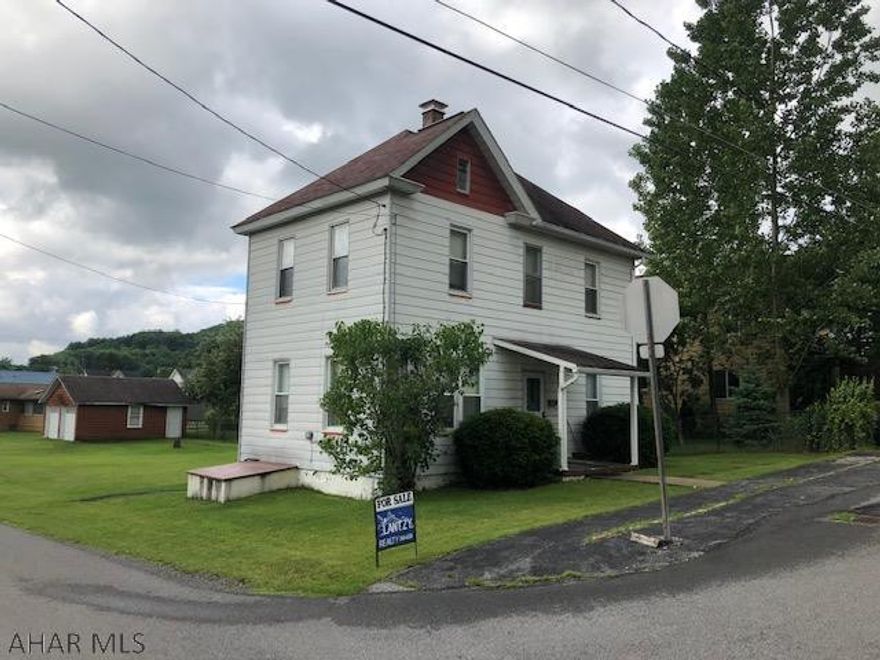 2 story aluminum sided 3 bedroom home with 2 car garage on quiet  fairly level residential corner lot.