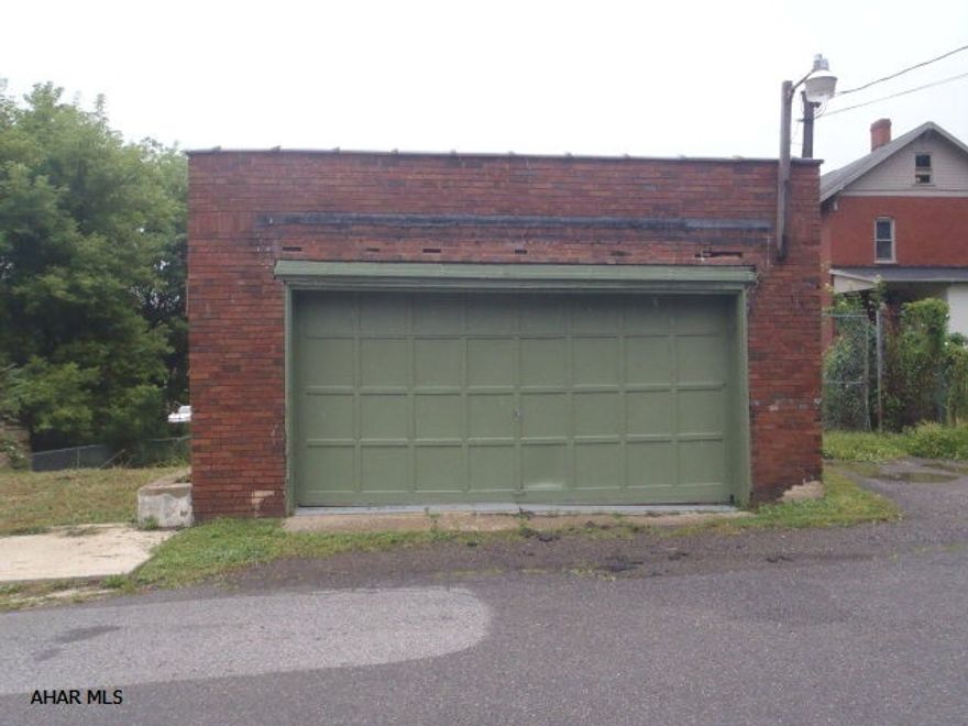 One story brick garage.  22 x 20 interior.  Workshop/office in back is 10 x 25.  Auto door opener.  100 amp CB.  Man door on side.  Roof is approximately 6 years old.  Great for car storage or contractor storage.  Public water and sewer are available on the street.  Zoned residential.  Why rent storage space when you can own it?