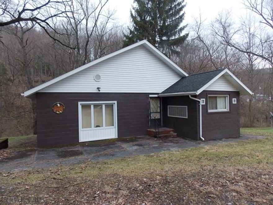 Adorable remodeled well kept home on a private half acre lot. One bedroom and one bath but bigger than you may think. The living room is huge (19' x 27'3") and could be divided to add another bedroom and bath. The Eat in Kitchen has been updated and the appliances stay. The seller restructured the entire roof when she purchased the home so all the wood is new as well. The bath and laundry have also been updated. Nothing to do but move in the this cute home.  House payment may be cheaper than rent.  In September the seller hooked up to public sewer so you won't have to.    Great location if you work in Altoona or State College!