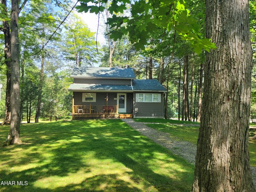 Situated in the center of over 3/4 of an acre of wooded land you  will feel the peace and privacy this cabin offers..  This one owner cozy cottage has been well maintained.   First floor bedroom and full bath offers the convenience of one floor living.  The loft can be used as a separate sleeping space, another living space or a storage area.  Step out onto the back deck and soak in the enjoyment of watching the deer and other wildlife close up.
The furnace, water heater and oil tank are out of sight but readily accessible in the walk in crawl space.
You will find added storage space in the shed.
This cabin is located in Glendale Yearound, a gated community adjacent to Prince Gallitzin State Park.  Community amenities include a heated seasonal pool, tennis/basketball/volleyball courts, dog park, clubhouse, pavilions, playgrounds, etc.