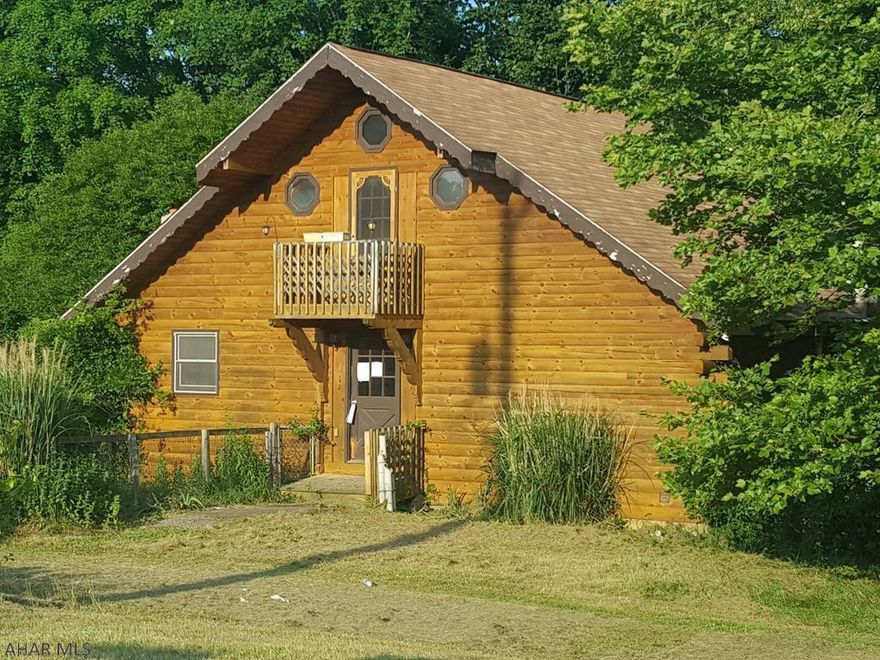 Loretto area log home on Cresson Lake. Unique property on large lot, but needs work throughout. AS-IS sale. Seller will make no repairs. Property on Community Sewage.