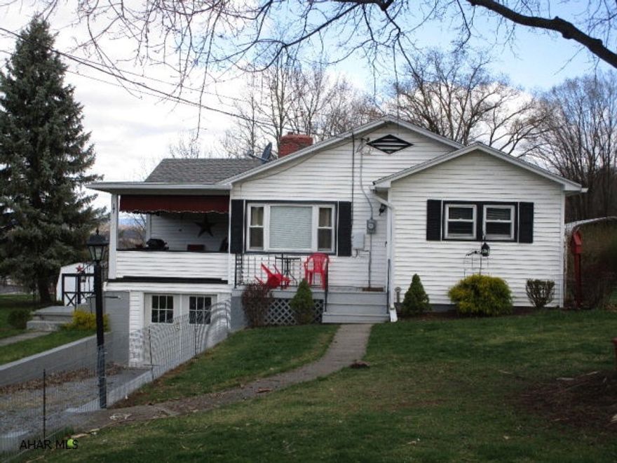 Well maintained and nicely updated ranch home just outside of town.  Living room w/ hardwood floors and gas fireplace, kitchen, dining room w/ hardwood floors, updated bathroom with ceramic tiled floor and shower surround and two bedrooms.  Oil hot water heat, pellet stove, 100-ampere electric and city water and sewer.  There is also a private well on the property that can be used for a garden, washing cars and other things.  Large lot, convenient location-short walk to town and storage shed.  Nice covered porch for relaxing and partially finished basement with double walk-out doors.  This is a nice home!!