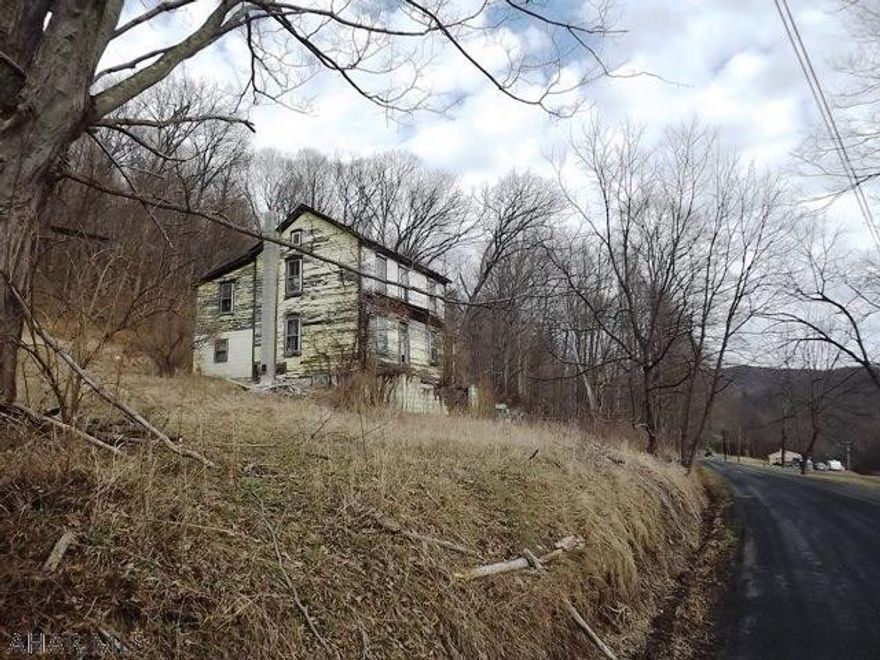 Offers a nice building site on 2.25 acres. Dilapidated house and trailer, do not enter. Specific details unknown as seller has not inhabited the property for many years. Close to Shawnee State Park and State Game Lands. Sold AS-IS.