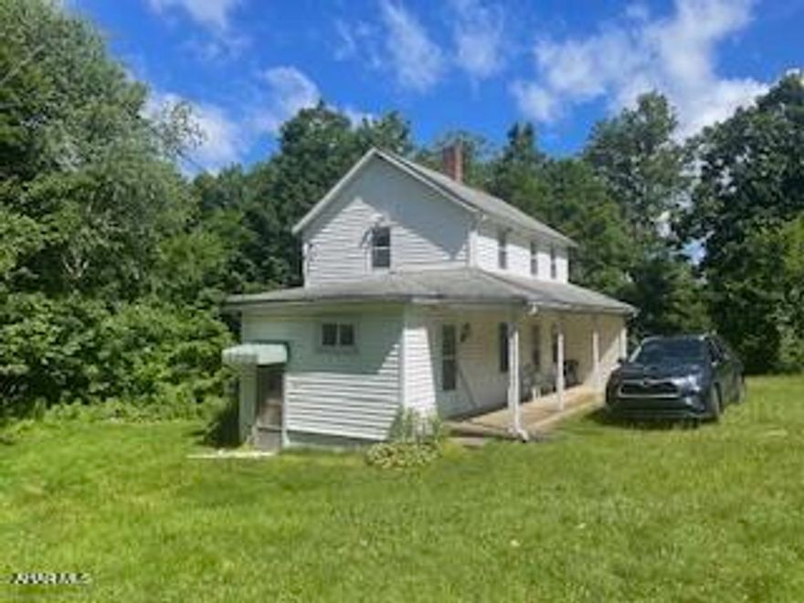 older, 2 story house with old septic system. We are selling this property as is, no tests. Owner will do no repairs. Neighbor says the septic leaches onto their land in the past.
Carrolltown boro sewer line is about 500' up the road and could tap on but it is uphill. The house is connected to public water. There is no driveway. Penndot would need to approve the access. This will be at the buyer's risk. {Property is sold in 'As Is Condition'.