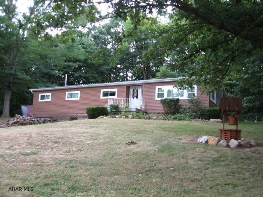 You should take a look at this well maintained doublewide home nestled on a tree shaded 1 acre lot.  This home has many upgrades:  roof, siding, windows, electric and a large garage with a bay to store your camper or RV.  Located near State Game Lands.  (Title is retired.)