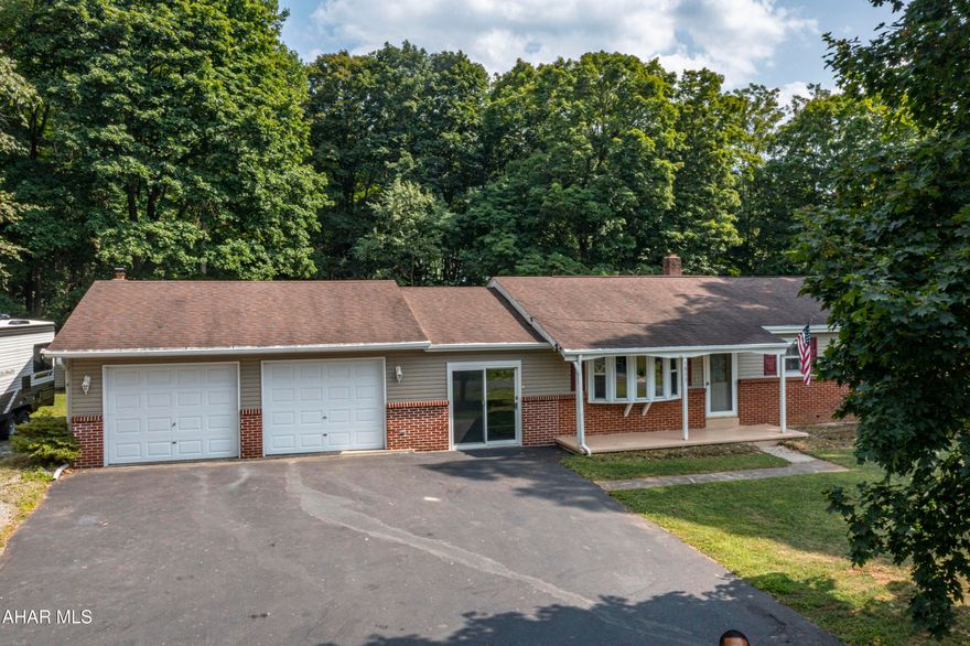 A well-maintained Ranch style home located in the country settings of Warriors Mark. This home features 3 bedrooms and 1 bath. It has a walk out partially finished basement and a 2-car garage. There is a closed in breezeway connecting the garage to the main house. The interior of the home revels original hardwood flooring under the carpet. The property sits on over an acre of land with a portion of it covered in wooded area, providing a serene and natural setting. Additionally, there is a large shed for extra storage needs. The location offers the convenience of being under a 30-minite drive to both Altoona and State College, making it an ideal location for commuting or accessing nearby amenities.