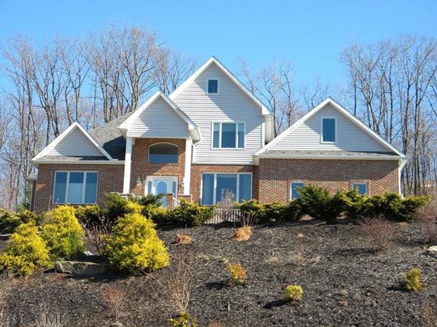 Beautifully maintained custom built home. 4 bedrooms, 3.5 baths, vaulted living room with hardwood floors and gas fireplace, Kitchen features amish maple cabinets, imported granite counters, eat in area with patio doors to covered patio. 1st floor laundry, formal dining room with hardwood floors and large picture window with mountain views. 1st floor master bedroom with walk in closet and en suite bath with jet tub. 2 nice bedrooms and full bath on 2nd floor with large bonus room for 4th bedroom. Full finished basement with brick fireplace and large wet bar, 3/4 bath, stairway to garage and french doors to a front patio to take in the views. So many custom features of this home that sits on 1.3 acres.