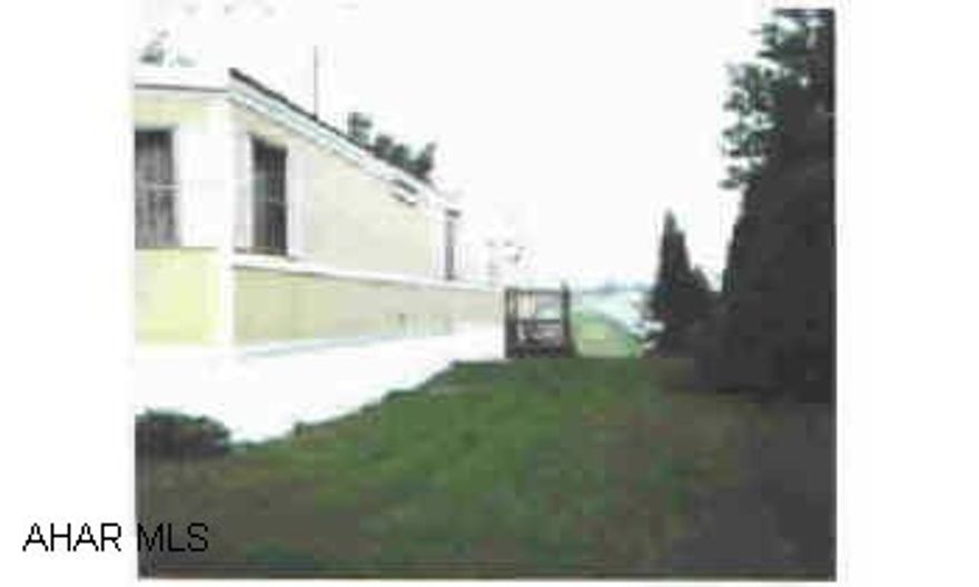 Well maintained moblie home with land. 1978 model. Brick wood-burning fireplace. Surround sound, covered deck, nice garage. New galvanized steel roof. Skiritng is vinyl. Lot size 83x100x92x106 Well maintained moblie home with land. 1978 model. Brick wood-burning fireplace. Surround sound, covered deck, nice garage. New galvanized steel roof. Skiritng is vinyl. Lot size 83x100x92x106  Vaulted ceiling