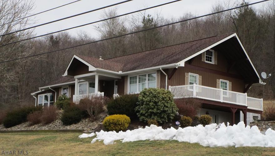 The VIEWS are priceless from this well maintained, one owner, 1 story situated on 1.37 acres with a 4 car heated, detached  garage/workshop with ample storage above.  The lower level offers a family room with a wood FP, den/office (newly carpeted) laundry room, full bath, workspace, 1 car garage & a fruit cellar. The main living area features a kit., Dining room w/bow window,  large living room with hardwood floors under the carpeting, a new sun room added in 2018, 3 bedrooms, & a full bath. Walk up to a bedroom and ample attic storage space on the 2nd floor. Central air in 2018...Newer windows and many other updates. This home has plaster walls.  If you are looking for country living but yet close to everything don't miss out on this one. Call me today for your personal showing.