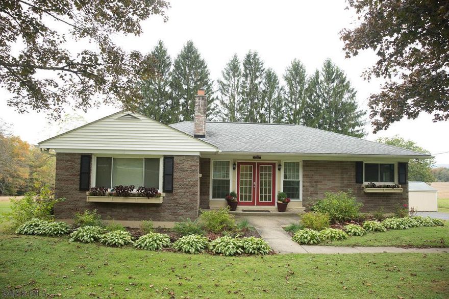 This beautiful ranch home is right outside Ebensburg Borough sitting on an acre lot.  This 3 bedroom 2 bath home has had extensive renovations.  Solid bamboo flooring throughout first floor.  Entertain family and friends in the open kitchen/living room, large island great for food prep, all new appliances included.  Get cozy this winter next to the stunning gas fireplace in living room.  Both baths are updated, new windows, new deck, new furnace, new gutters, new landscaping.  Relax in the evenings on the new deck either watching the sunset or deer eating right from the apple trees.  One car detached garage, shed for storage.  The large basement can be finished for additional family living space. Central air.  Call today!