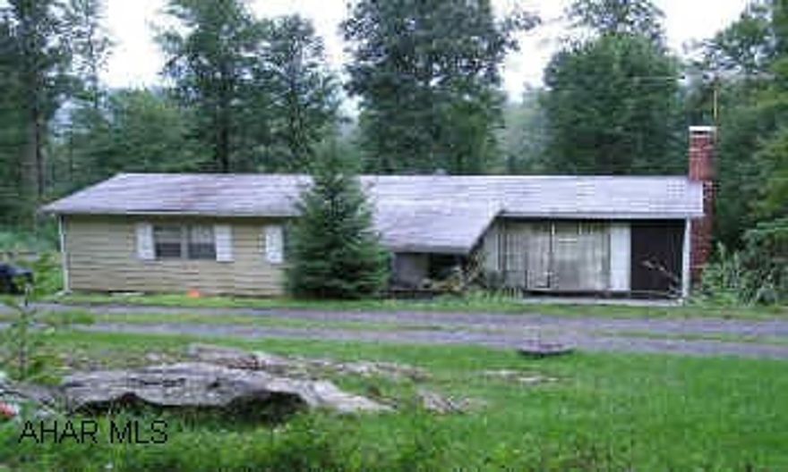 Doublewide on full foundation w/3BR/1.5BA, partial basement on nearly 2 acres in Breezewood Park.  Fireplace in living room and basement. Private location. Offered AS-IS, WHERE -IS.