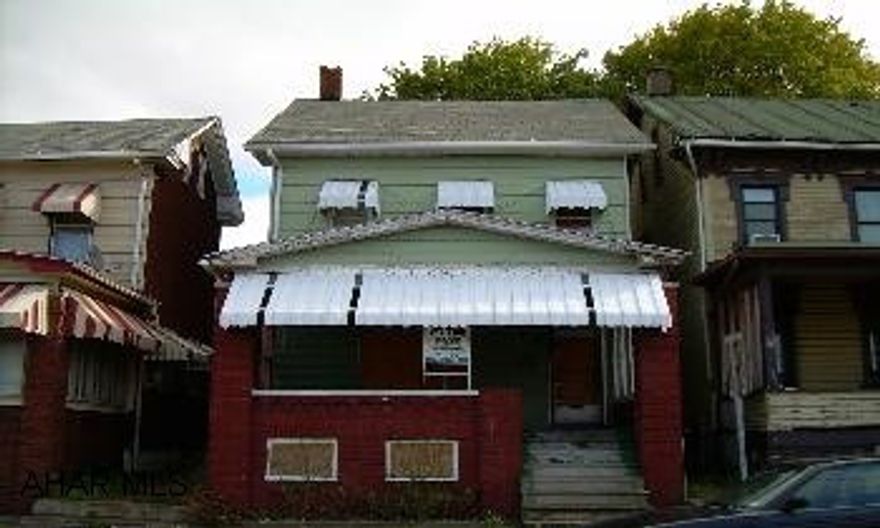 2 1/2 story aluminum sided w/ brick front porch. Home has been vacant for a couple of years.  Great investment property, turn some sweat equity into a rental income.  Property needs work, being sold as is.