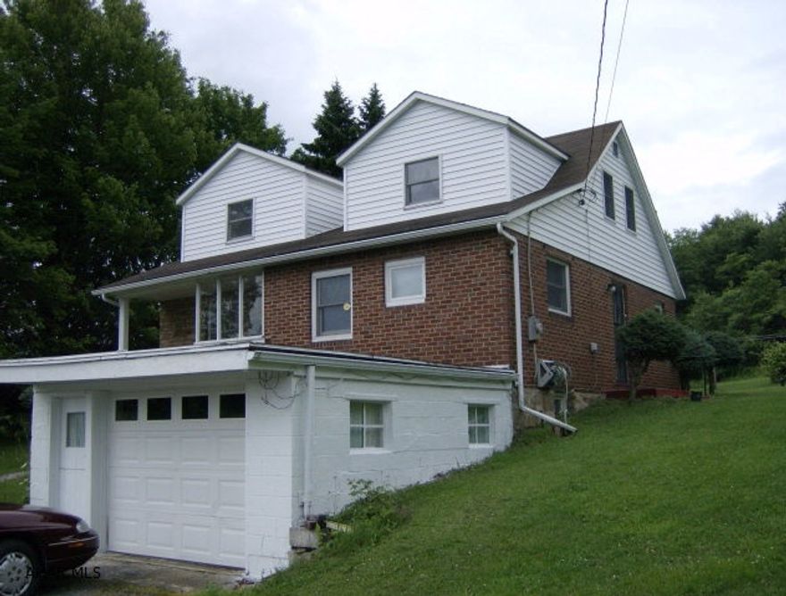 Stone/brick & vinyl sided 4 BR Cape Cod style home on 4.7 acres. Spacious country kitchen. Refinished hardwood floors throughout. 1 car attached garage, 1 car detached garage with loft & 42 x 45 concrete block building.