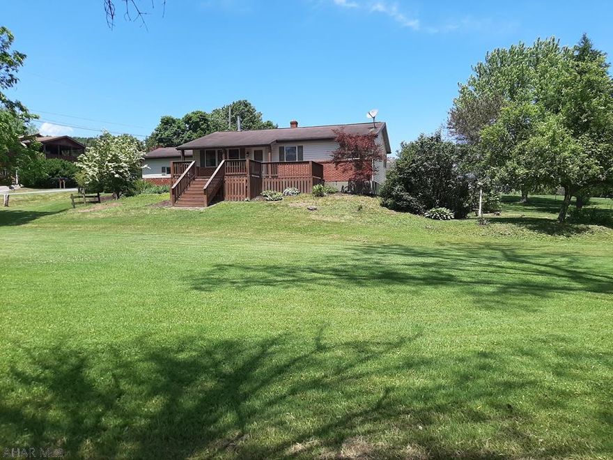 Nicely landscaped, 1-story in East Freedom.  Features include hardwood floors; a large, eat-in kitchen; hot water heat; a very nice tool shed; a wood burner; 2 semi-finished rooms in the basement; a huge deck overlooking the gorgeous yard, and a 1-car garage.