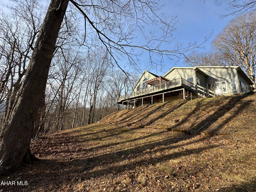 Who says you can't have it all? Check out this beautiful property adjacent to the American Legion Country Club in Mount Union. This quality home has a great layout with an open main living area. The main living area has a living room with vaulted ceilings and a wall of windows letting in lots of natural light, the kitchen features lots of cabinet space with a walk-in pantry, island and bar area, the huge composite deck can be accessed from the living room or dining area making this the perfect spot for entertaining, the deck has a wonderful view of the river when the leaves are off the trees and lots of privacy all summer long, there is a sunroom off the kitchen, the owner suite has a large walk-in closet and full bath, the upper level offers two bedrooms with a full bath and a bonus room that could be used for an office or nursery, the lower level has two additional bedrooms with a full bath, the bedrooms all have nice sized closets, the basement opens to ground level and is mostly finished with the unfinished areas turned into closets that offer lots of storage, a laundry area and even a half bath, this home is well thought out and offers lots of space for you, your family and friends and all your belongings, call today to schedule your showing, more pictures to follow, the owner is in the process of moving