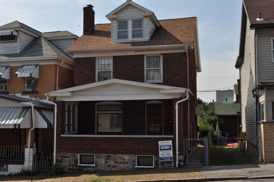 2.5 Story 3 Bedroom 1.5 Bath Brick Home features original woodwork pocket doors fireplace large closets 2 car block garage. updated 100 Amp breaker panel. new carpeting. first floor bath.