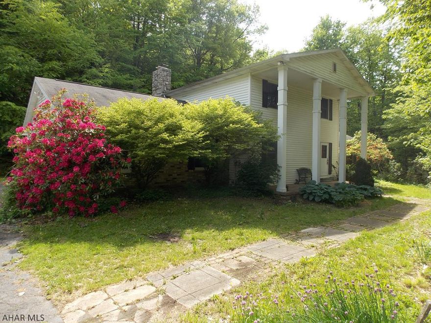 A rare find only 10 minutes from Altoona!  Spacious living room with an open floor plan to the formal dinning room. Office on the first floor would make a great 4th bedroom. Lovely family room on the first floor that features a bar and a cozy fireplace. Convenient first floor laundry and a 1/2 bath. Huge master bedroom with 2 closets and a master bathroom.  2 car attached garage and plenty of parking. Enjoy watching the wildlife from the back deck. So peaceful and private! All of this on 36.7 Acres! If you love hunting and recreational activities this property is perfect!