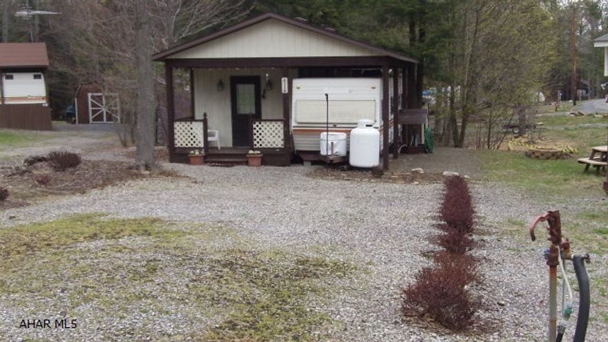 This camp has it all.  Lots of room for the whole family to visit and sleep.  In addition to the bedroom, the addition comes with two futons that fold down for more sleeping space.  If the night is a little chilly, fire up the propane fireplace to take the edge off.  Outside, cook a hot dog or make some smores at your fire pit, have a picnic lunch at the picnic table that is nestled in next to the creek running at the edge of the campsite.  A shed is included to keep your outside toys or lawn furniture.  The seller is leaving most of the furniture so you are ready to pack your fishing gear and head for Glendale Lake.  Take the kids to the pool or one of the playgrounds, or take Fido to the dog park.  Your whole family will enjoy this getaway.