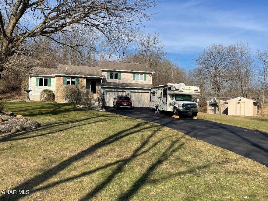 If you are looking for a beautiful 3 bedroom, 2.5 bath home, here it is!! This home is situated on 2.69 acres, nestled against the hillside in Hollidaysburg school district with quick access to RT 22, 36 and I-99. As you enter the home, you will find the spacious kitchen with plenty of storage and a lot of natural sunlight. The dining room is open to the large living room area and desirable heated sunroom with a private deck! The extra-wide staircase and hallway lead you to the upper level which is where you will find the master bedroom with double closets and full bath. The master bath offers a jetted tub, new vanity and shower. There are two additional bedrooms and full bath that completes the upper level. The lower level is where you find the 1/2 bath and laundry area/mud room and the large heated 2-car garage with new insulated doors and easy access to the large flat yard where you will find the (2) 12x16 sheds both with electric. The unfinished basement is the perfect space for storage or can easily be made into a family room; with this large bonus area the possibilities are endless. Don't miss your chance to see this beautiful home, call today to get your private tour scheduled.