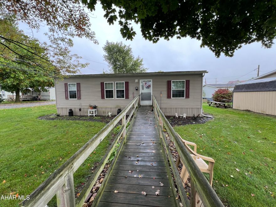 This 2014 double wide home is situated on a rented lot and includes a ramp for easy entry. 

Inside, you will find a spacious open living area that flows into the eat-in kitchen. 

The home also boasts a dedicated laundry room. 

This home has three bedrooms and two bathrooms. The primary suite features a walk-in closet and an en-suite bathroom. The second bathroom is designed with accessibility in mind, featuring a generous walk - in shower.