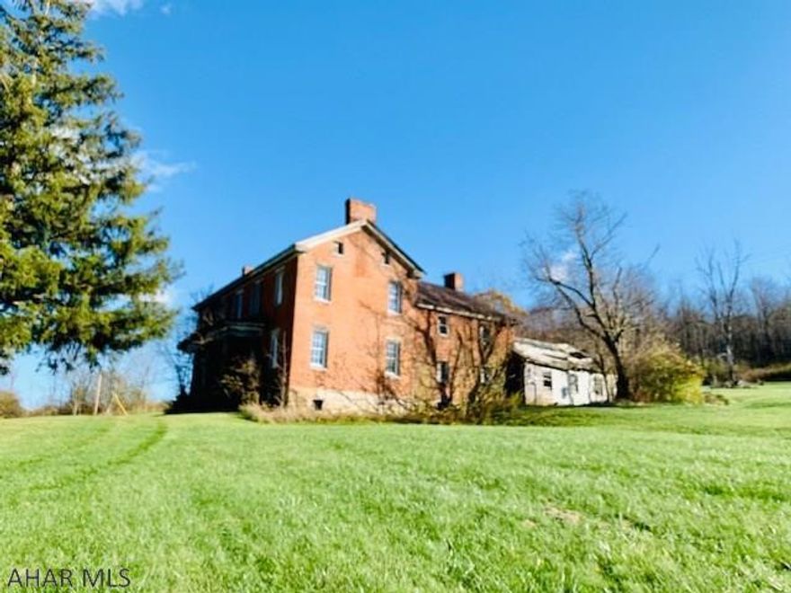 Built in the 1800s, this two-story brick home on 22 +/- acres is the perfect restoration project for someone that has the passion and the vision or someone that is looking to build from the ground up. The property is close to downtown Bedford so if you enjoy antiquing, shopping and dining you don't have far to go. If you love year-round outdoor activities, Shawnee lake, Blue Knob Ski Resort and the Omni Bedford Springs Resort are only a short distance away. Come check out the possibilities!  Well and Septic is present but unknown if they work. (Use CAUTION when entering the house and all rooms). Taxes will be prorated upon subdivision approval. Property is being sold As-IS.
