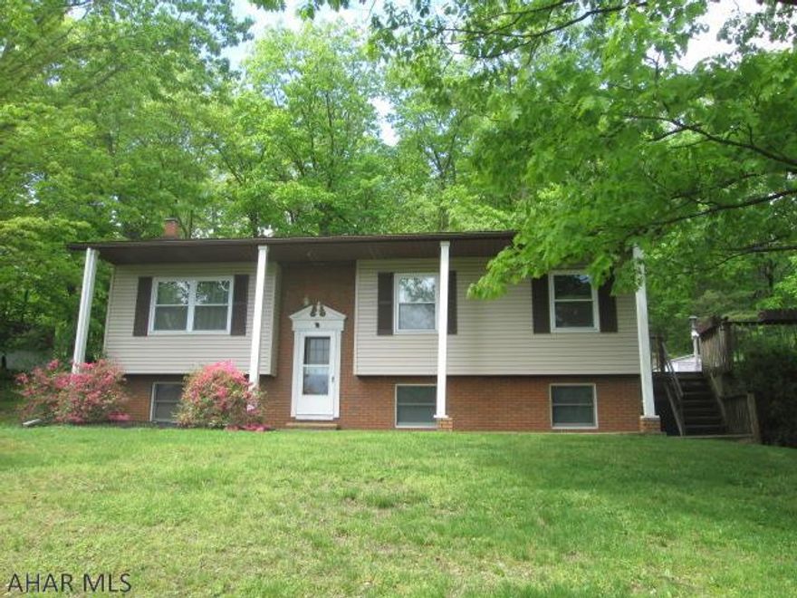 This 3 bedroom home is nestled on an acre of ground, you will find yourself relaxing on the deck & enjoying the wildlife.  A serene, private setting yet within minutes to local shopping conveniences.  The home is being sold  "As Is" condition.  Basement has a room and rough in for a 1/2 bath.  Toilet and vanity in basement just need connected.  House has 2 split unit wall mounted heat pumps, one in the main level living room and one in the lower level basement recreation room.  So much potential in this home, needs updated, but definitely reflected in the list price.