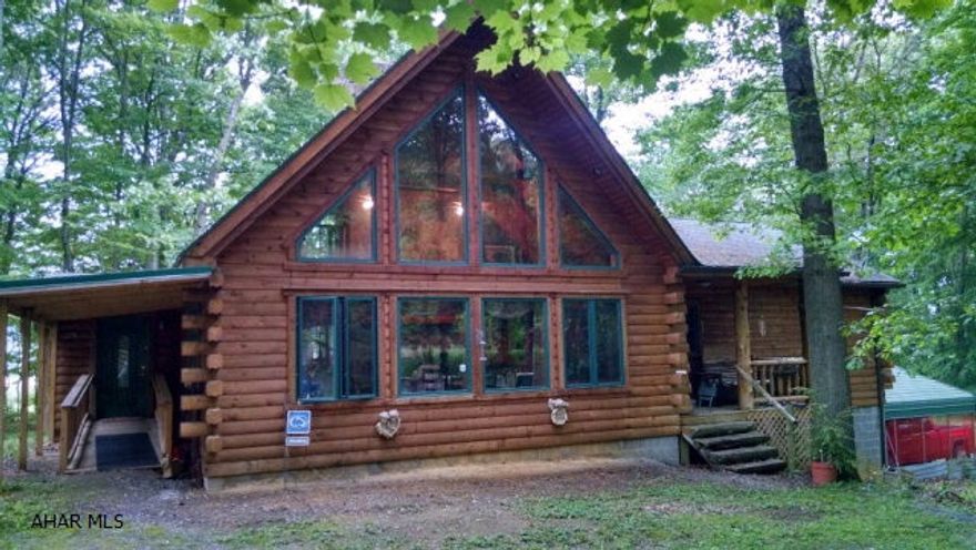 Gorgeous Log home! Beautiful A frame design, private wooded setting. Vaulted knotty pine ceiling and walls, custom quality throughout! Radiant floor heating/OHW or wd/coal-the choice is yours. Lower level finished, Family Room, Kitchen, Fireplace/Huge 25x24 area-addit. living space. Must see! Det. 24x24 garage/workshop/2-car carport