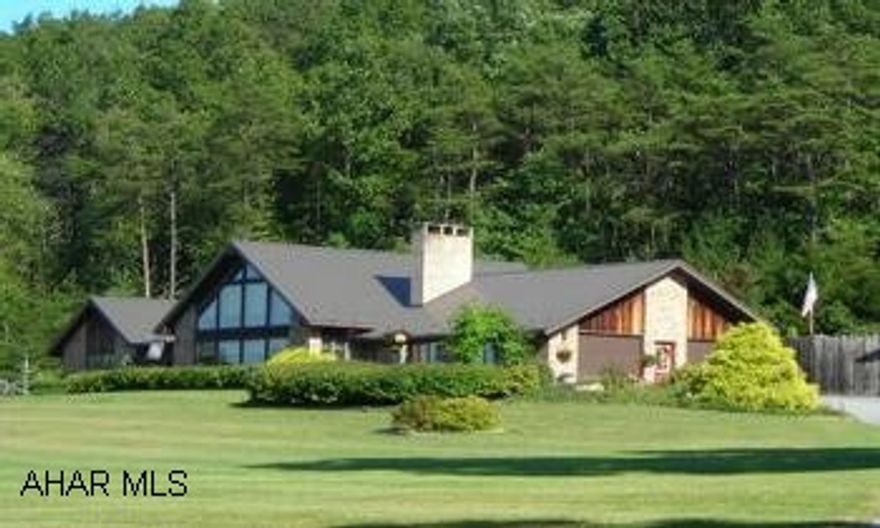 See Comments, property to be subdivided to equal about 20+/- acres before closing.  Proposed division available from listing agent. Unique property located in the foothills of the Allegheny Mountains and sits on approximately 20 acres!  The brick and cedar house offers 3 bedrooms, 3 baths, livingroom and dining room combo, solid oak kitchen PLUS a 3-season room.  The ten surface acre stocked lake can be viewed from most rooms!!  An extensive paito area surrounds the 32'x16' inground sport pool! Huge four car detached garage/carport/workshop/office offers endless possibilities.  This gem is in the Fishertown area of Bedford County and near the historic town of Bedford, offering affordable taxes and healthy living! Quick access to I-99, Route 56, PA Turnpike. DC 2 hrs, Pittsburgh 1.5 hrs. SOLD price reflects 26 acres, main house, brick house, tractor shed, garden shed, huge outbuilding with 4 garages, enclosed RV port, upstairs with office/apartment space.