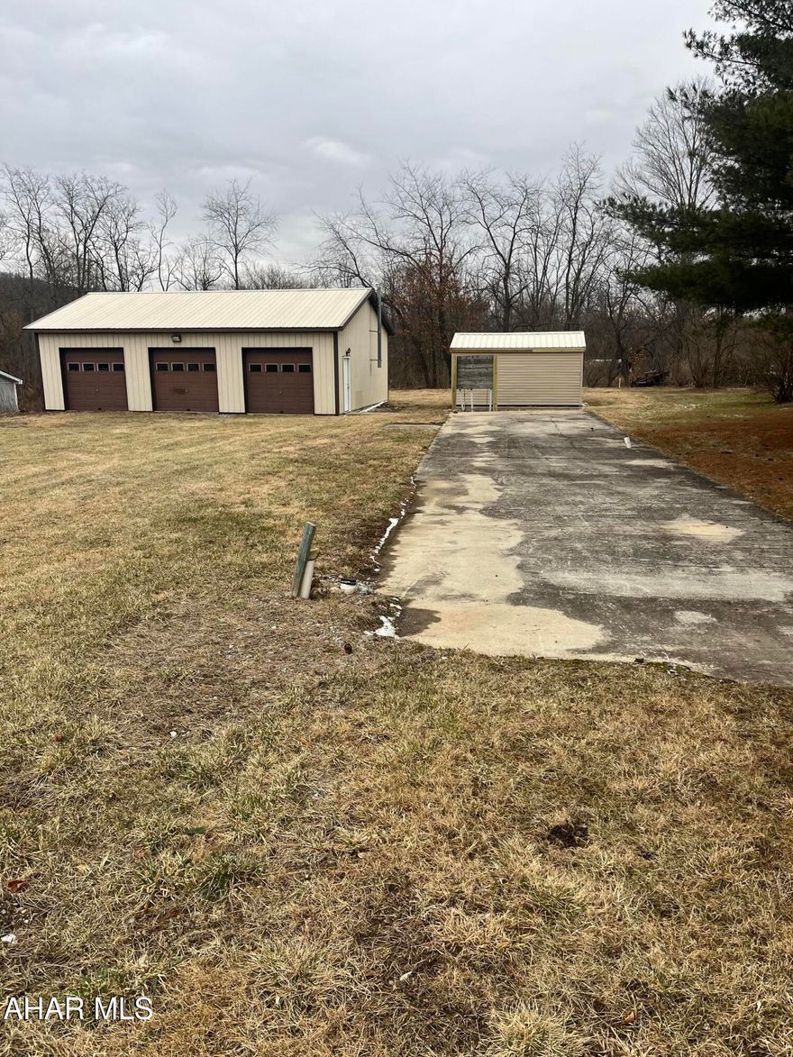 3 car garage (30x40), shed, cement pad for mobile home situated on nice level lot. You could build a home or bring one in.